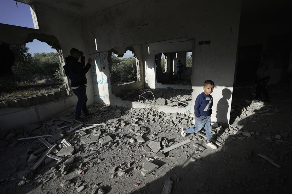 Palestinians check demolished home in the West Bank village of Silat al-Harithiya, near Jenin, Saturday, May 7, 2022. Israeli forces demolished a home of Omar Jaradat who was part of a group who shot and yeshiva student Yehuda Dimentman in the West Bank in December 2021. (AP Photo/Majdi Mohammed)