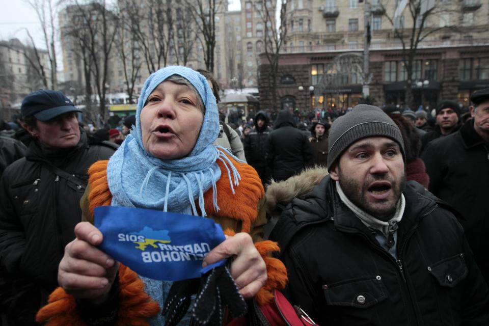 Supporters of Ukrainian President Viktor Yanukovych arguing with a anti-government protesters in Kiev, Ukraine, Saturday, Feb. 8, 2014. Thousands of people angered by months of anti-government protests in the Ukrainian capital converged on one of the protesters' barricades Saturday, but retreated after meeting sizeable resistance.(AP Photo/Sergei Chuzavkov)