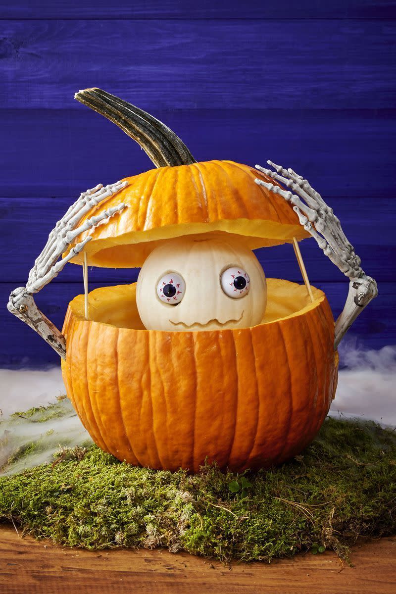 <p>Double the pumpkins, double the fun: Place a smaller gourd — white works best if you want it to mimic a skull — inside a big orange pumpkin for a pleasant surprise. </p><p><em><a href="https://www.womansday.com/home/crafts-projects/g950/funny-pumpkin-carving-ideas/" rel="nofollow noopener" target="_blank" data-ylk="slk:Get the tutorial at Woman's Day »;elm:context_link;itc:0;sec:content-canvas" class="link ">Get the tutorial at Woman's Day »</a></em></p>