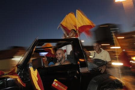 Supporters wave party flags of Luis Guillermo Solis, presidential candidate of the Citizens' Action Party (PAC), while travelling in a vehicle during the presidential election run-off in San Jose April 6, 2014. REUTERS/Juan Carlos Ulate