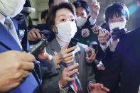 Japan's Olympics Minister Seiko Hashimoto, center, is surrounded by reporters at the Lower House in Tokyo, Wednesday, Feb. 17, 2021. Japan's Kyodo news agency, citing a source “familiar with the matter,” said Wednesday, a selection committee will ask Hashimoto to become the new president of the Tokyo Olympic organizing committee. Hashimoto, who could be named this week, would replace Yoshiro Mori who was forced to resign last week after he made demeaning comments about women — basically saying they talk too much.(Meika Fujio/Kyodo News via AP)