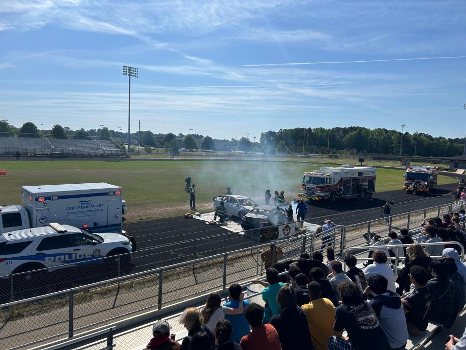 Students of Jack Britt Senior High School are shown a demonstration of the scene of a drunk driving accident during the "Broken Dreams" event organized by the Hope Mills Police Department, April 25, 2024.