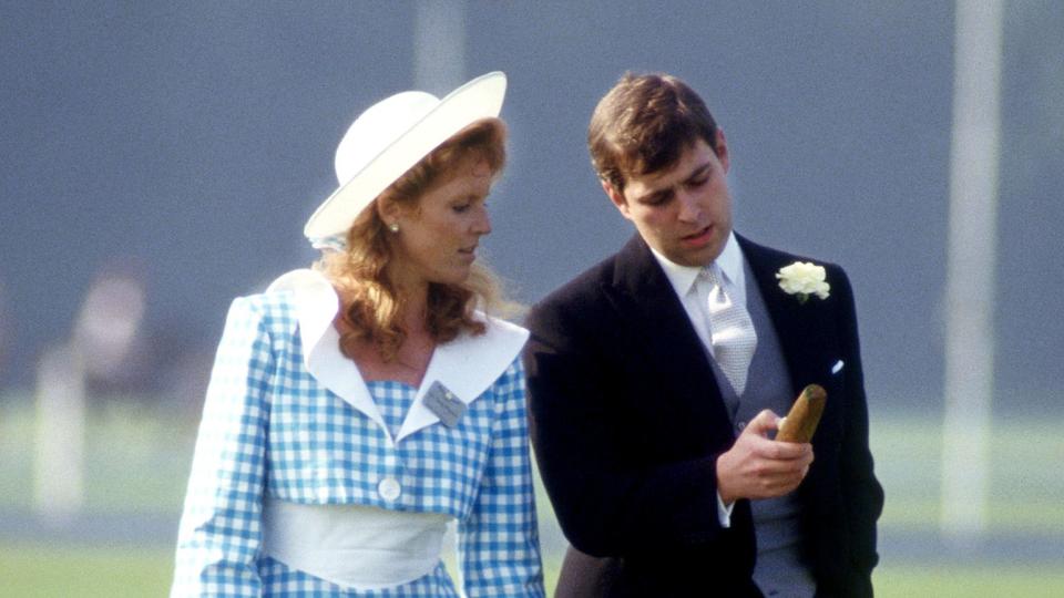 Sarah, Duchess of York and Prince Andrew examine a broken polo mallet