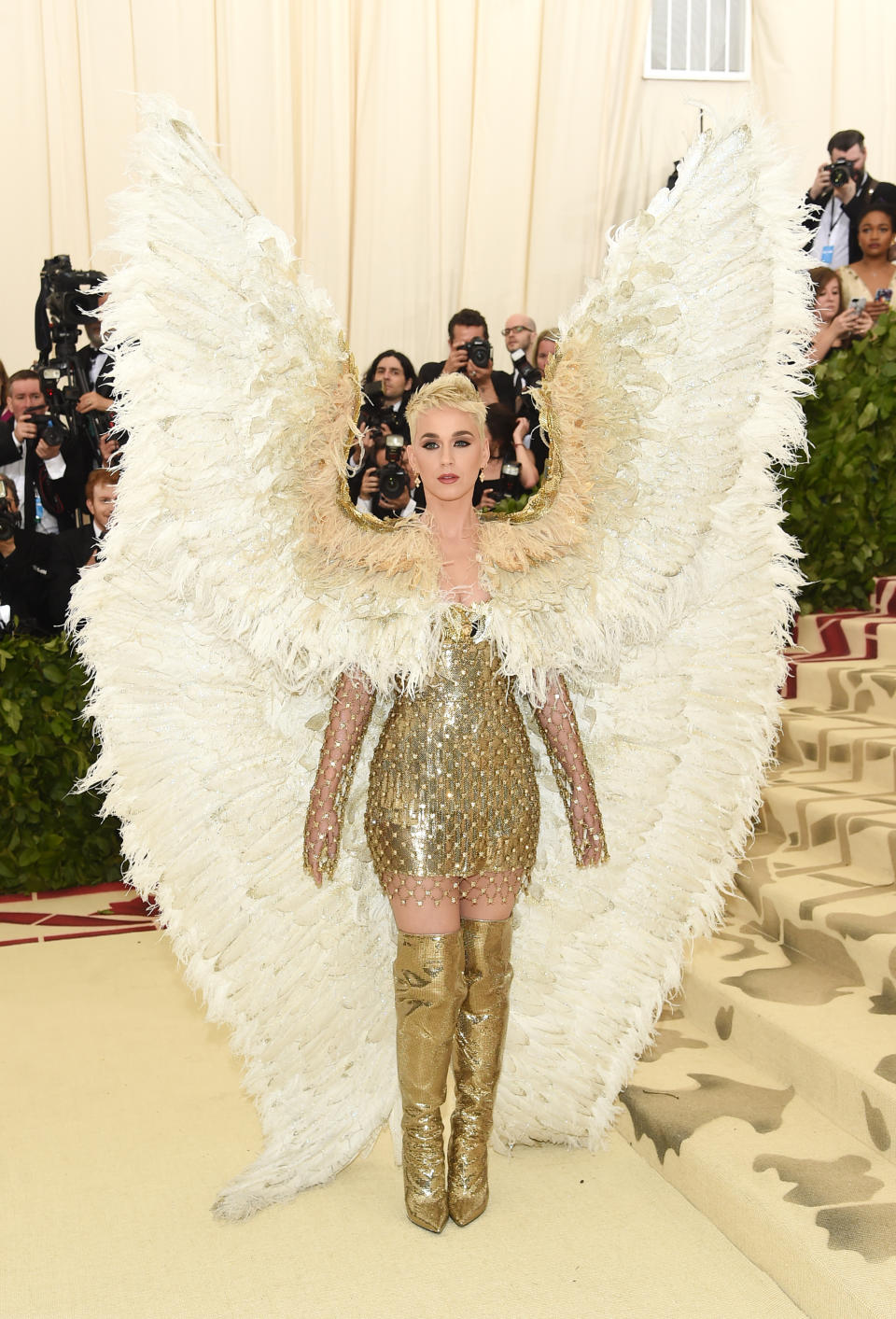 <p>We already knew that subtlety isn’t Katy Perry’s forte, but she went ahead and reminded us anyway at the Met Gala wearing a gold Versace mini dress and enormous angel wings. [Photo: Getty] </p>