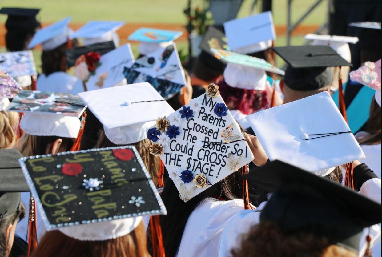 Students decorated the tops of their mortarboards with personal messages, including this senior whose cap read, "My parents crossed the border so I could cross the stage!"