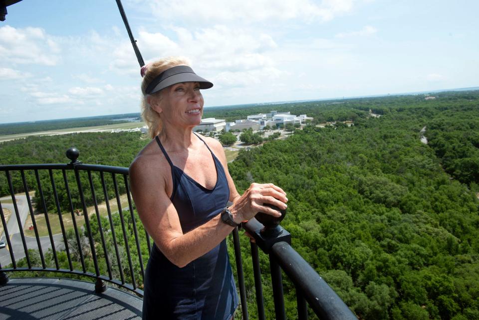 Kim Scholl takes in the scenic views from the top of the historic lighthouse at NAS Pensacola, which remains closed to those without a Department of Defense ID or Veteran Health Identification Card. Scholl, whose husband is a former Blue Angels pilot, visited the lighthouse for the first time Thursday while her husband was at a conference on the base.