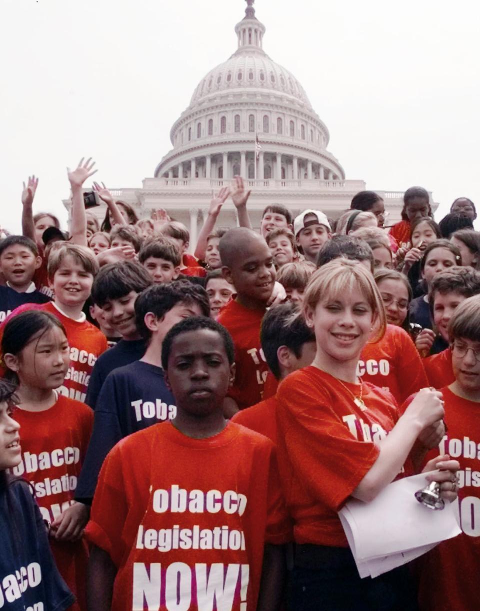 FILE - In this Wednesday, May 20, 1998 file photo, Olympic gold medalist Tara Lipinski, right, stands with school children in an anti-tobacco rally on Capitol Hill in Washington. The rally was sponsored by the Campaign for Tobacco-Free Kids. (AP Photo/Dennis Cook)