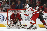 Arizona Coyotes goaltender Antti Raanta (32) makes a save on a shot by Carolina Hurricanes right wing Andrei Svechnikov (37) as Coyotes center Derek Stepan (21) defends during the second period of an NHL hockey game Thursday, Feb. 6, 2020, in Glendale, Ariz. (AP Photo/Ross D. Franklin)