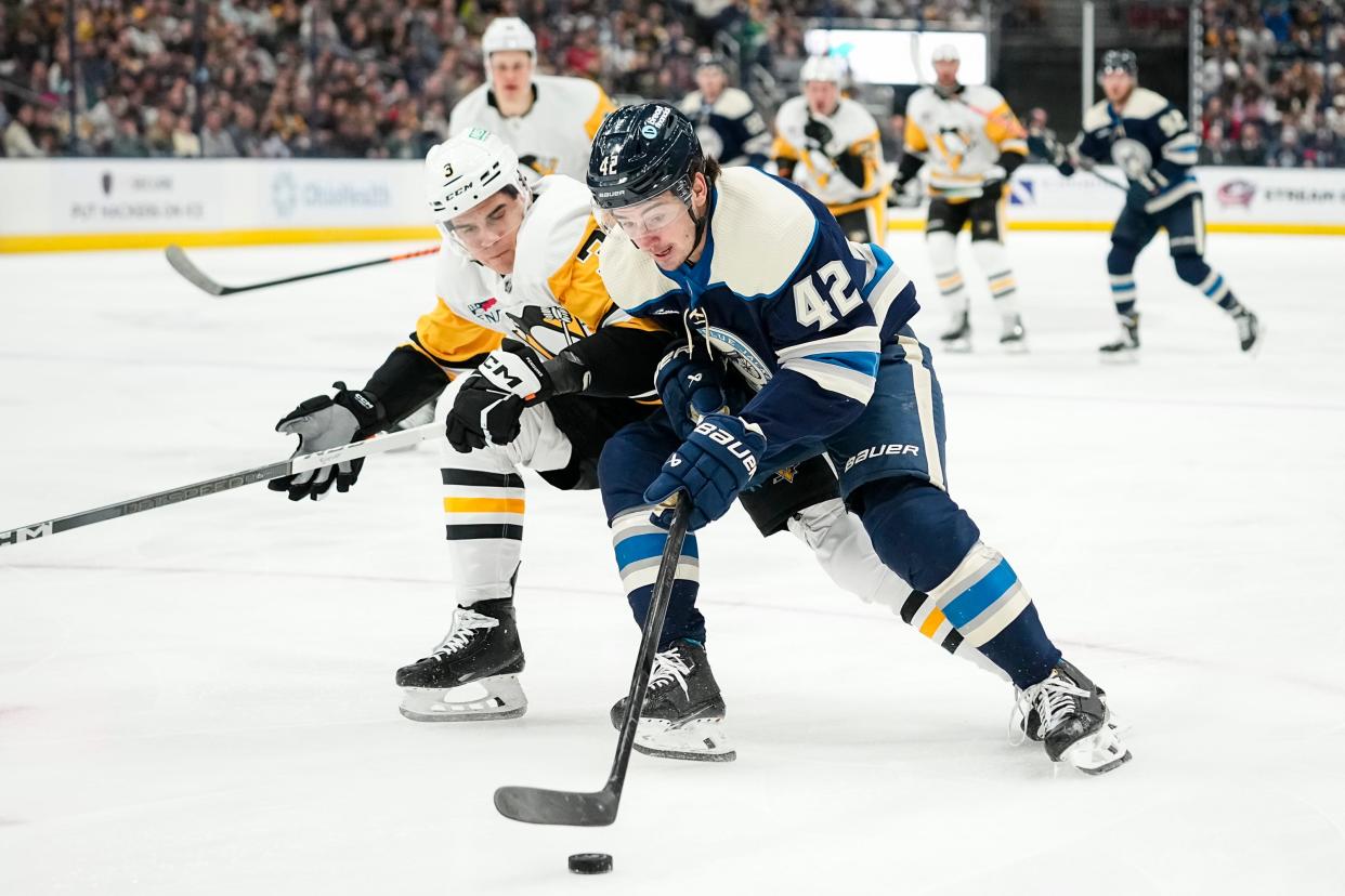 Mar 30, 2024; Columbus, Ohio, USA; Columbus Blue Jackets center Alexandre Texier (42) skates by Pittsburgh Penguins defenseman Jack St. Ivany (3) during the first period of the NHL hockey game at Nationwide Arena.