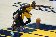 Los Angeles Clippers' Reggie Jackson (1) is fouled by Indiana Pacers' Caris LeVert (22) during the second half of an NBA basketball game, Tuesday, April 13, 2021, in Indianapolis. (AP Photo/Darron Cummings)