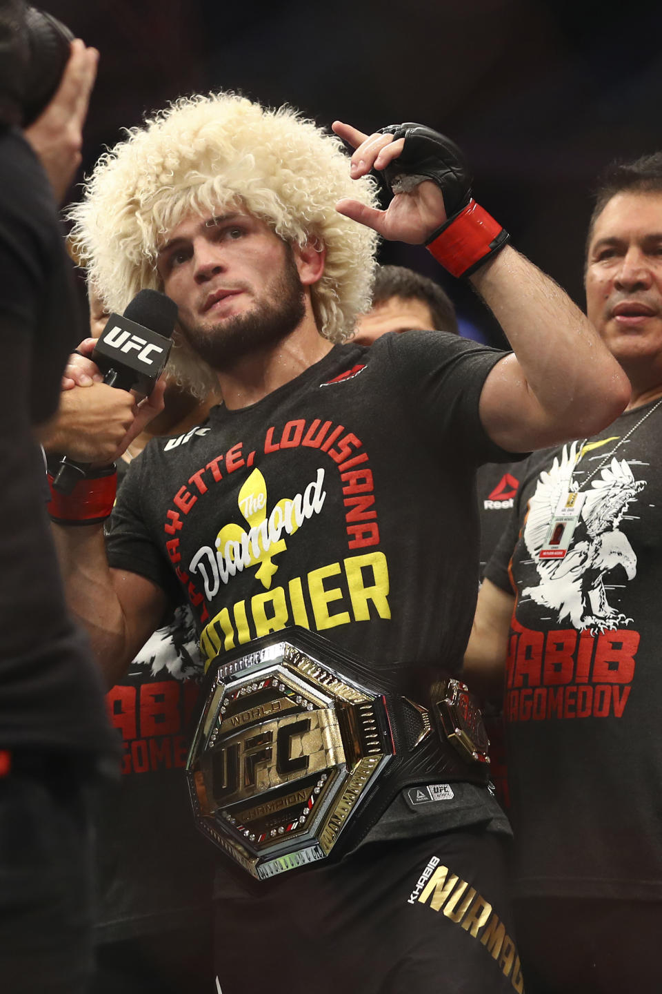 Russian UFC fighter Khabib Nurmagomedov speaks after wining against UFC fighter Dustin Poirier, of Lafayette, La., during Lightweight title mixed martial arts bout at UFC 242, in Yas Mall in Abu Dhabi, United Arab Emirates, Saturday , Sept.7 2019. (AP Photo/ Mahmoud Khaled)