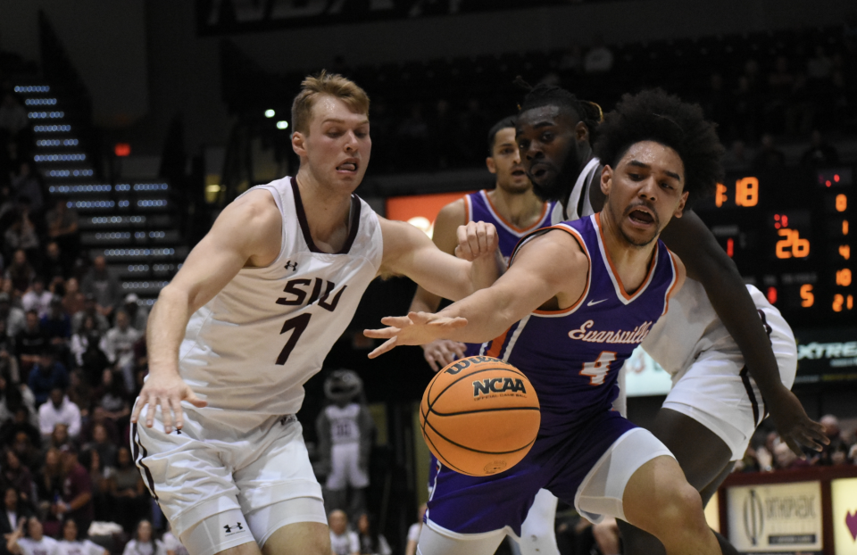 Evansville men's basketball guard Marvin Coleman II reaches for the ball against Southern Illinois' Marcus Domask.