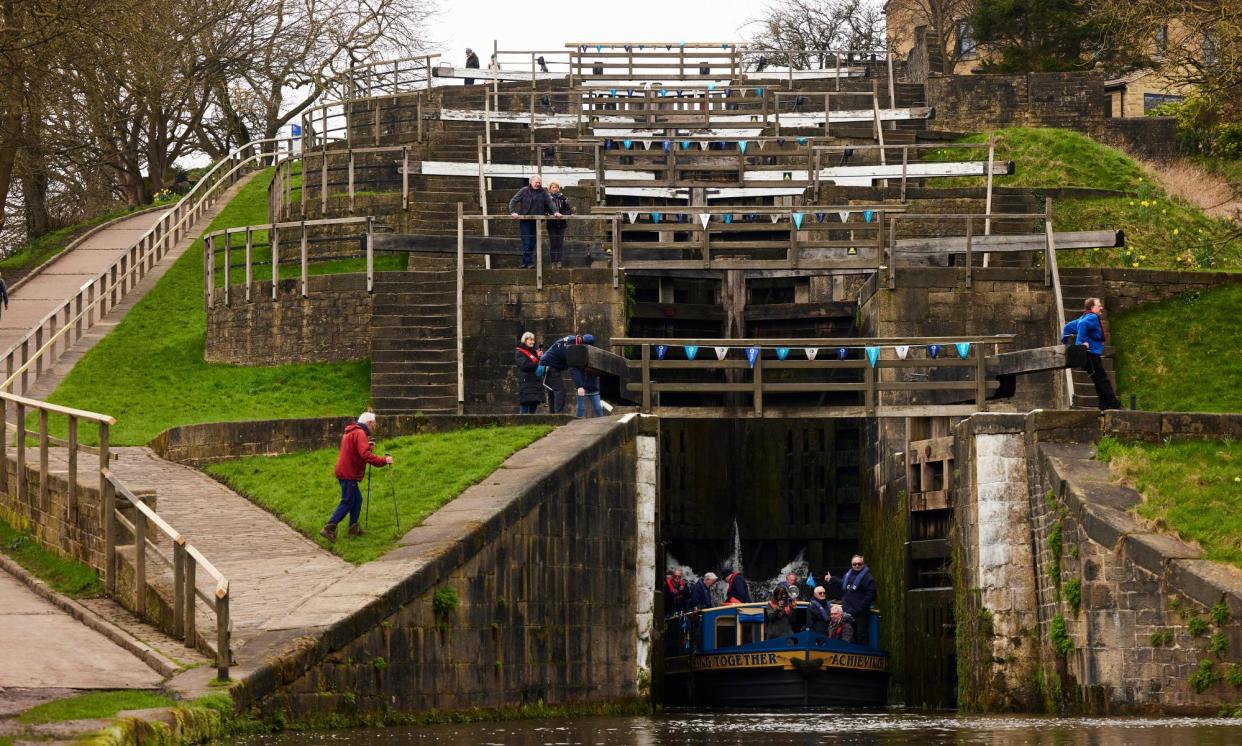 <span>A canal boat passing through Bingley Five Rise locks in West Yorkshire.</span><span>Photograph: Christopher Thomond/The Guardian</span>