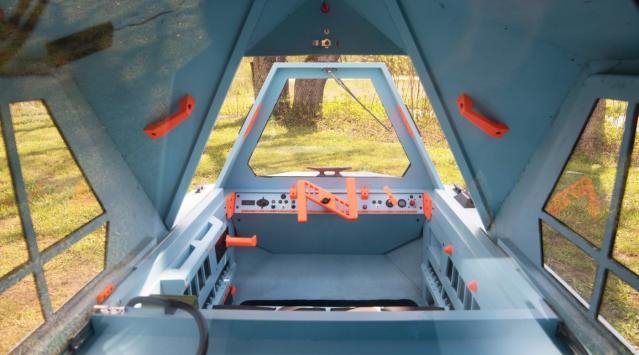 The interior of the Z-Triton camper boasts enough lounge/sleep space for two, as well as all the boat controls. 