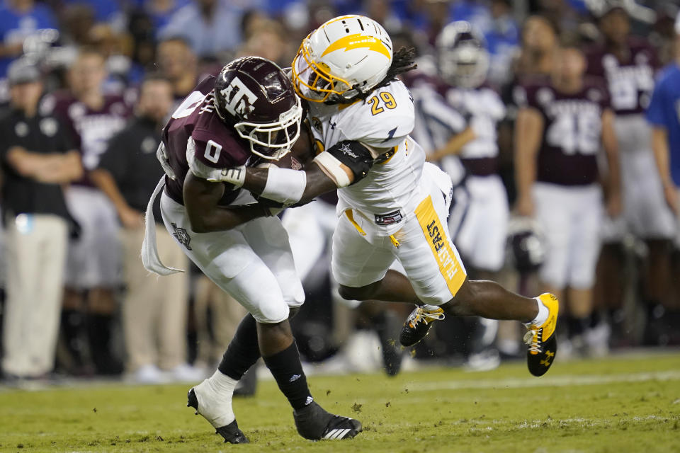 Texas A&M wide receiver Ainias Smith (0) is tackled by Kent State safety C.J. Holmes (29) after making a catch during the first half of an NCAA college football game on Saturday, Sept. 4, 2021, in College Station, Texas. (AP Photo/Sam Craft)