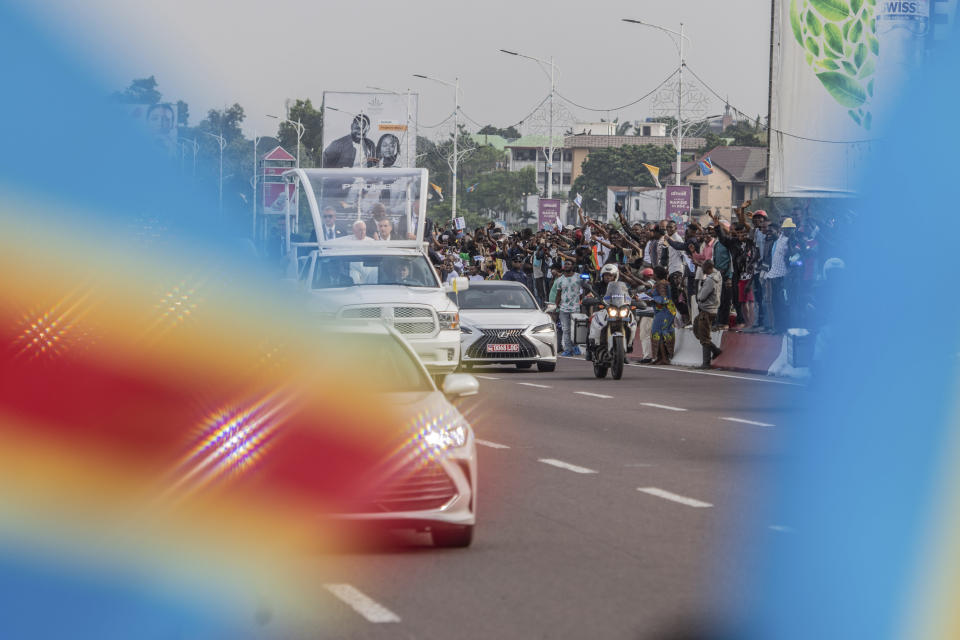 Pope Francis greets well-wishers after arriving in Kinshasa, Congo, Tuesday Jan. 31, 2023. Francis is in Congo and South Sudan for a six-day trip, hoping to bring comfort and encouragement to two countries that have been riven by poverty, conflicts and what he calls a "colonialist mentality" that has exploited Africa for centuries. (AP Photo/Moses Sawasawa)