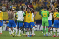 Brazil's players celebrate their team's win over Uruguay at the end of a qualifying soccer match for the FIFA World Cup Qatar 2022 against Uruguay at Arena da Amazonia in Manaus, Brazil, Thursday, Oct.14, 2021. Brazil won 4-1. (AP Photo/Andre Penner)