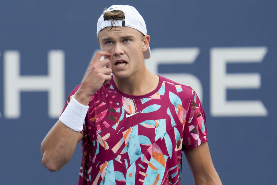 Holger Rune, of Denmark, reacts during a match against Roberto Carballes Baena, of Spain, during the first round of the U.S. Open tennis championships, Monday, Aug. 28, 2023, in New York. (AP Photo/John Minchillo)