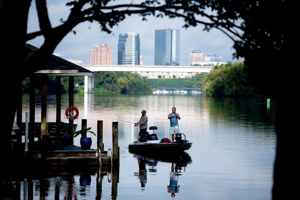 Anglers fish for bass along the banks of the Tennessee River near Island Home Park in Knoxville. Despite what locals call it, the water near downtown is technically a reservoir.