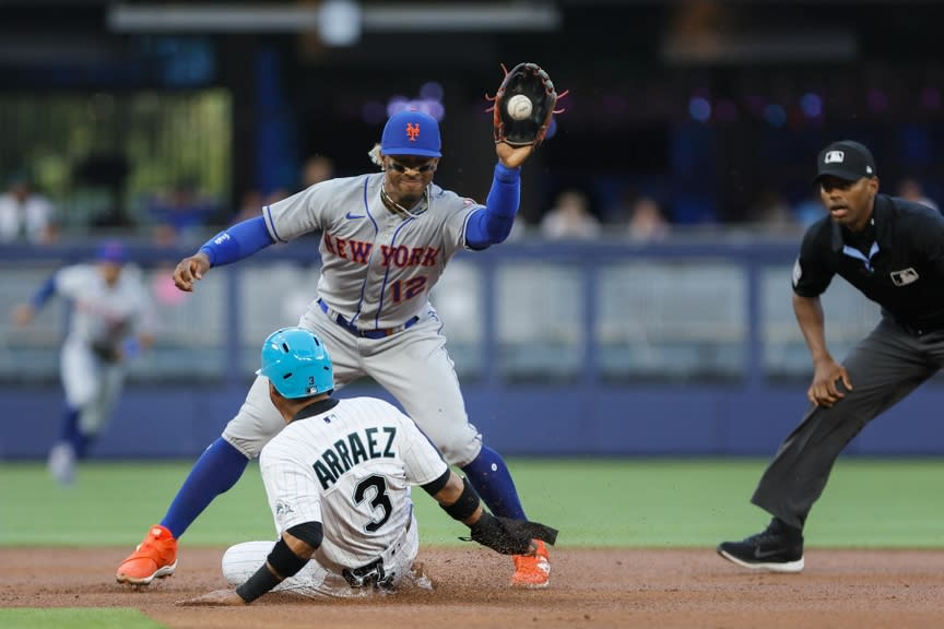 New York Mets shortstop Francisco Lindor (12) catches a throw from first baseman Pete Alonso (not pictured) for the out against Miami Marlins second baseman Luis Arraez (3) during the first inning at loanDepot Park.