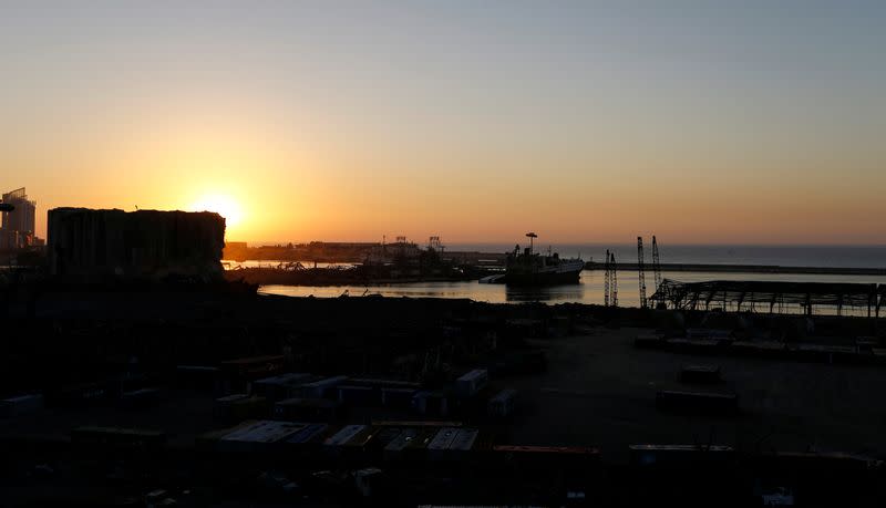 A view shows the damaged port area in the aftermath of a massive explosion at sunset in Beirut