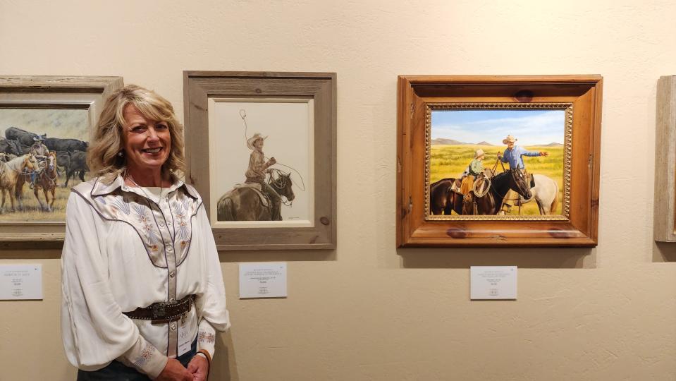 Kathryn Merril, an artist from Oklahoma, stands with her artwork at the AQHA Art Show Aug. 12 in Amarillo.