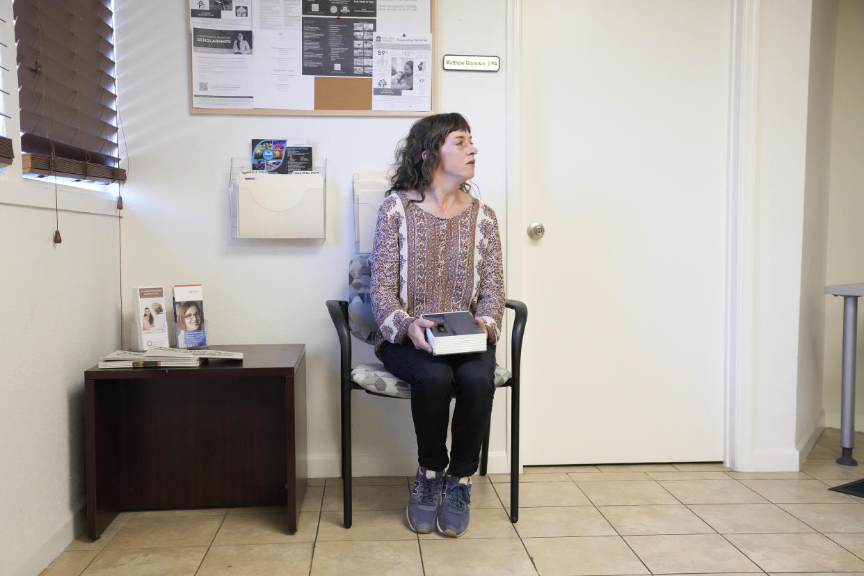 Methadone patient Irene Garnett, 44, of Phoenix, sits in the waiting room of a clinic in Scottsdale, Ariz., on Monday, Aug. 26, 2024. (AP Photo/Ross D. Franklin)