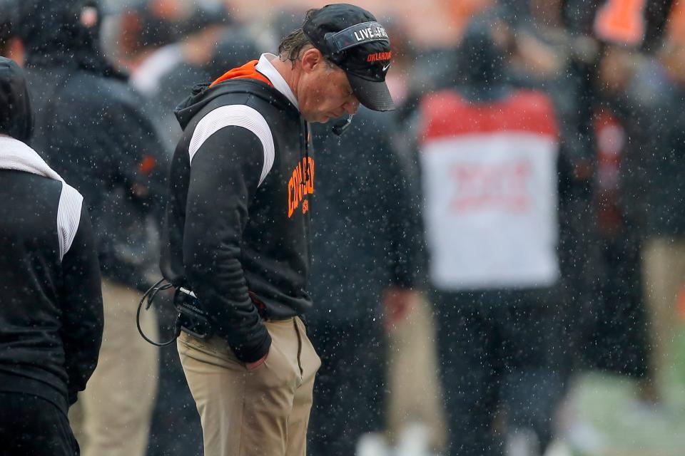 Oklahoma State Cowboys head coach Mike Gundy looks down as he stands on the sideline during a college football game between Oklahoma State and West Virginia at Boone Pickens Stadium in Stillwater, Okla., Saturday, Nov. 26, 2022. West Virginia won 24-19. 