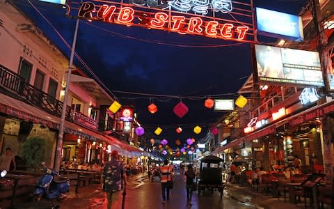 The bright lights of Pub Street in Siem Reap - Credit: GETTY