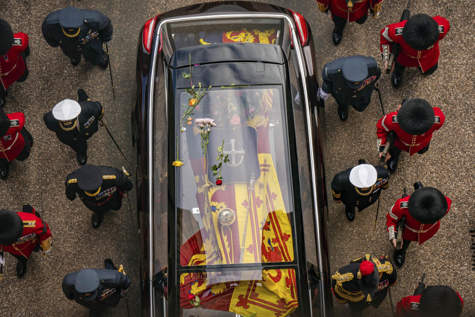 Flowers on the hearse carrying the coffin of Queen Elizabeth II as it arrives at Windsor Castle for the Committal Service in St George's Chapel in Windsor, England, Monday, Sept. 19, 2022. (Aaron Chown/Pool Photo via AP)