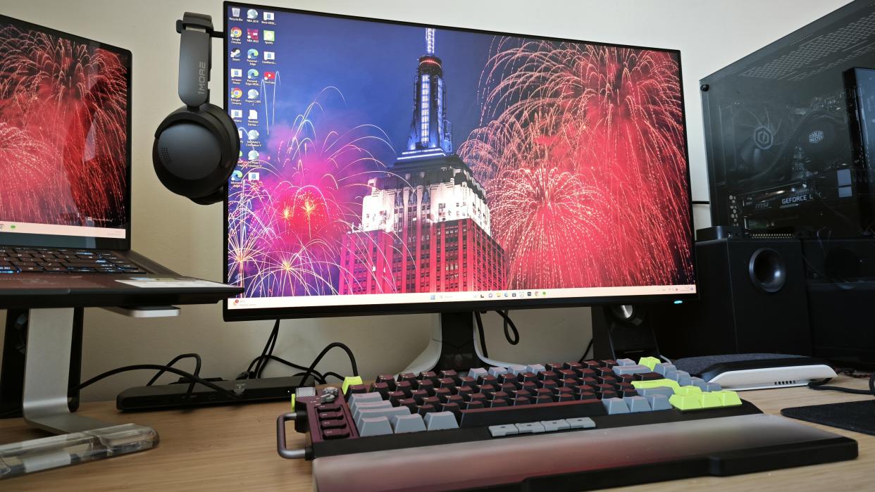  An Alienware AW2723DF monitor sitting on a wooden desk 