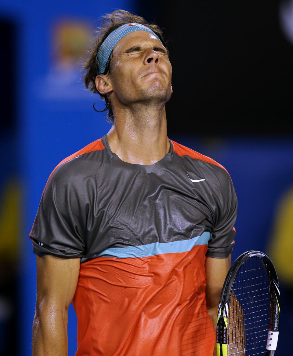 Rafael Nadal of Spain reacts after losing a point to Roger Federer of Switzerland during their semifinal at the Australian Open tennis championship in Melbourne, Australia, Friday, Jan. 24, 2014.(AP Photo/Aaron Favila)