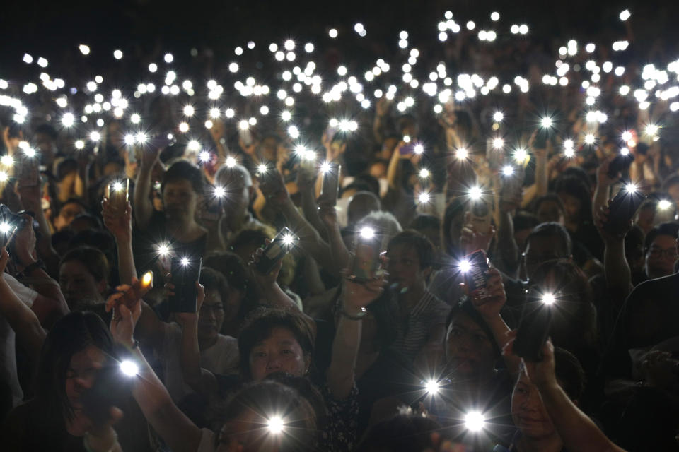 Attendees hold up their lit mobile phones during a rally by mothers in support of student protesters in Hong Kong on Friday, Jan. 5, 2019. Student unions from two Hong Kong universities said Friday that they have turned down invitations from city leader Carrie Lam for talks about the recent unrest over her proposal to allow the extradition of suspects to mainland China. (AP Photo/Andy Wong)