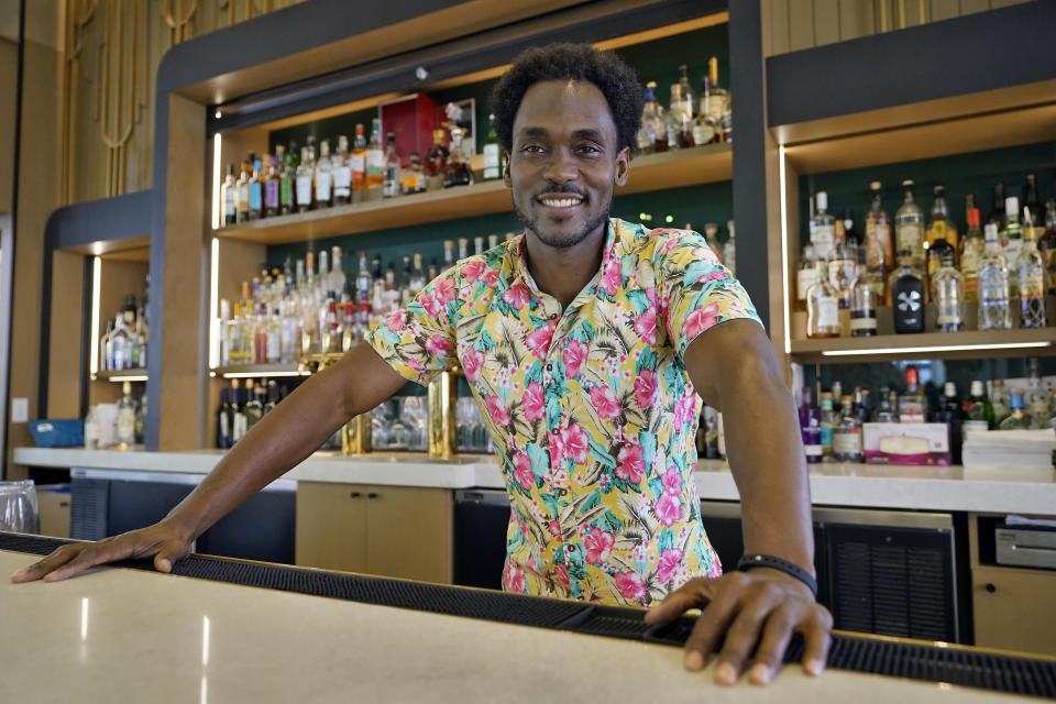 Jared Wofford poses for photos at the Don Cesar hotel Thursday, June 17, 2021, in St. Petersburg, Fla. Wofford portrays a bartender at the hotel in the Amazon series "Life's Rewards," an original, scripted TV series commissioned by travel marketers in St. Petersburg and Clearwater, Florida, seeking to draw quarantine-weary tourists to the area's sugar sand beaches. (AP Photo/Chris O'Meara)