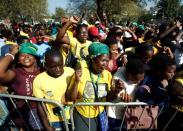 Supporters of former President Jacob Zuma sing as he appears in the High Court where he faces charges that include fraud, corruption and racketeering, in Pietermaritzburg