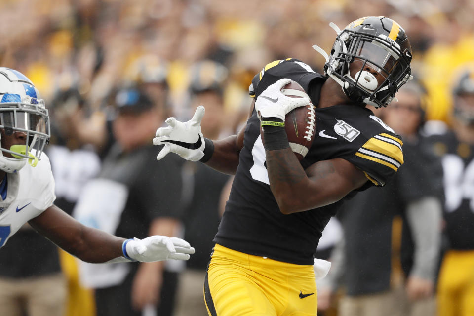 Iowa wide receiver Ihmir Smith-Marsette catches a pass ahead of Middle Tennessee cornerback Teldrick Ross, left, during the first half of an NCAA college football game, Saturday, Sept. 28, 2019, in Iowa City, Iowa. (AP Photo/Charlie Neibergall)