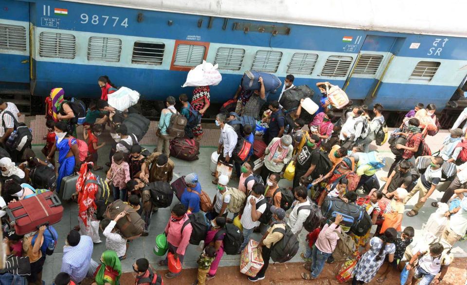 <span class="caption">Migrant workers arriving from Mumbai waiting to board a local passenger train to Danapur station.</span> <span class="attribution"><a class="link " href="https://www.gettyimages.com/detail/news-photo/migrants-arrived-from-mumbai-walk-to-board-a-local-news-photo/1216637234?adppopup=true" rel="nofollow noopener" target="_blank" data-ylk="slk:Photo by Santosh Kumar/Hindustan Times via Getty Images;elm:context_link;itc:0;sec:content-canvas">Photo by Santosh Kumar/Hindustan Times via Getty Images</a></span>