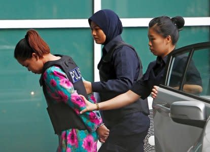 Indonesian Siti Aisyah who is on trial for the killing of Kim Jong Nam, the estranged half-brother of North Korea's leader, is escorted as she arrives at the Department of Chemistry in Petaling Jaya, near Kuala Lumpur, Malaysia October 9, 2017. REUTERS/Lai Seng Sin