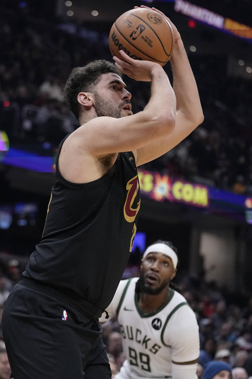 Cleveland Cavaliers forward Georges Niang shoots in front of Milwaukee Bucks Jae Crowder (99) during the first half of an NBA basketball game Wednesday, Jan. 17, 2024, in Cleveland. (AP Photo/Sue Ogrocki)