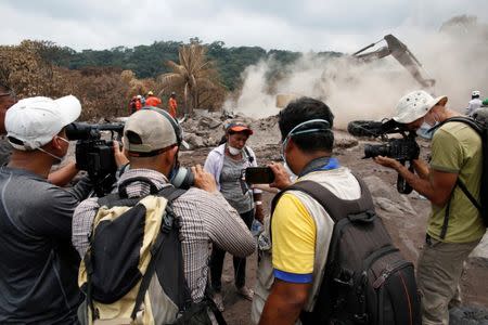 Eufemia Garcia, 48, who lost 50 members of her family during the eruption of the Fuego volcano, speaks to the media after rescue workers found human remains at her sister's house in San Miguel Los Lotes in Escuintla, Guatemala, June 14, 2018. REUTERS/Carlos Jasso