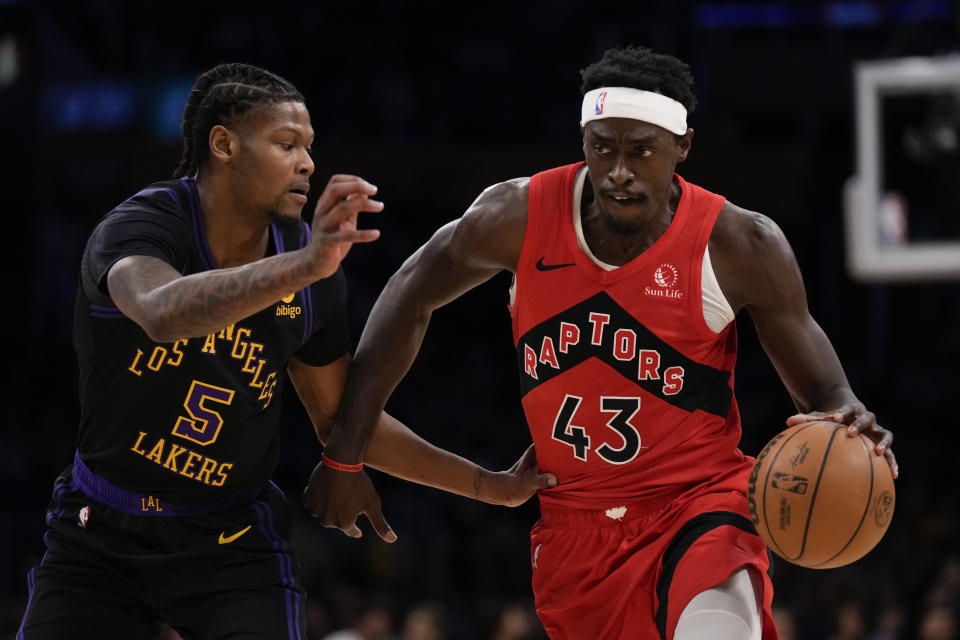 Los Angeles Lakers forward Cam Reddish (5) defends against Toronto Raptors forward Pascal Siakam (43) during the first half of an NBA basketball game in Los Angeles, Tuesday, Jan. 9, 2024. (AP Photo/Ashley Landis)