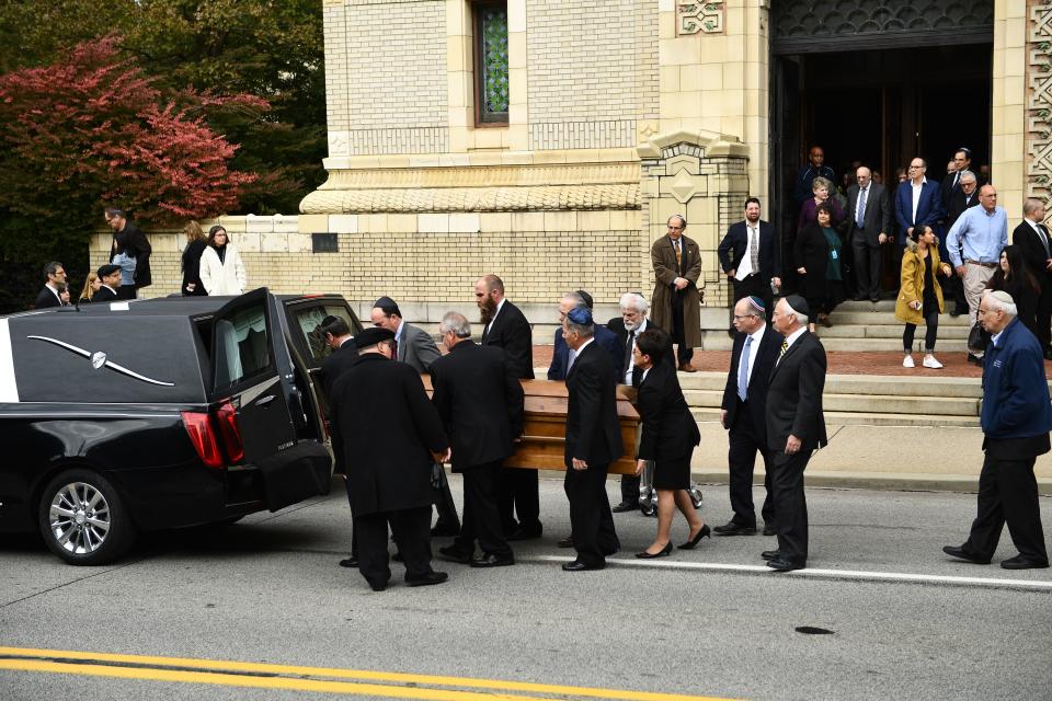 Mourners gather as a casket is carried outside the Rodef Shalom Congregation, where the funeral for shooting victims Cecil Rosenthal and David Rosenthal was held Oct. 30, 2018 in Pittsburgh, Pennsylvania. (Photo: BRENDAN SMIALOWSKI via Getty Images)