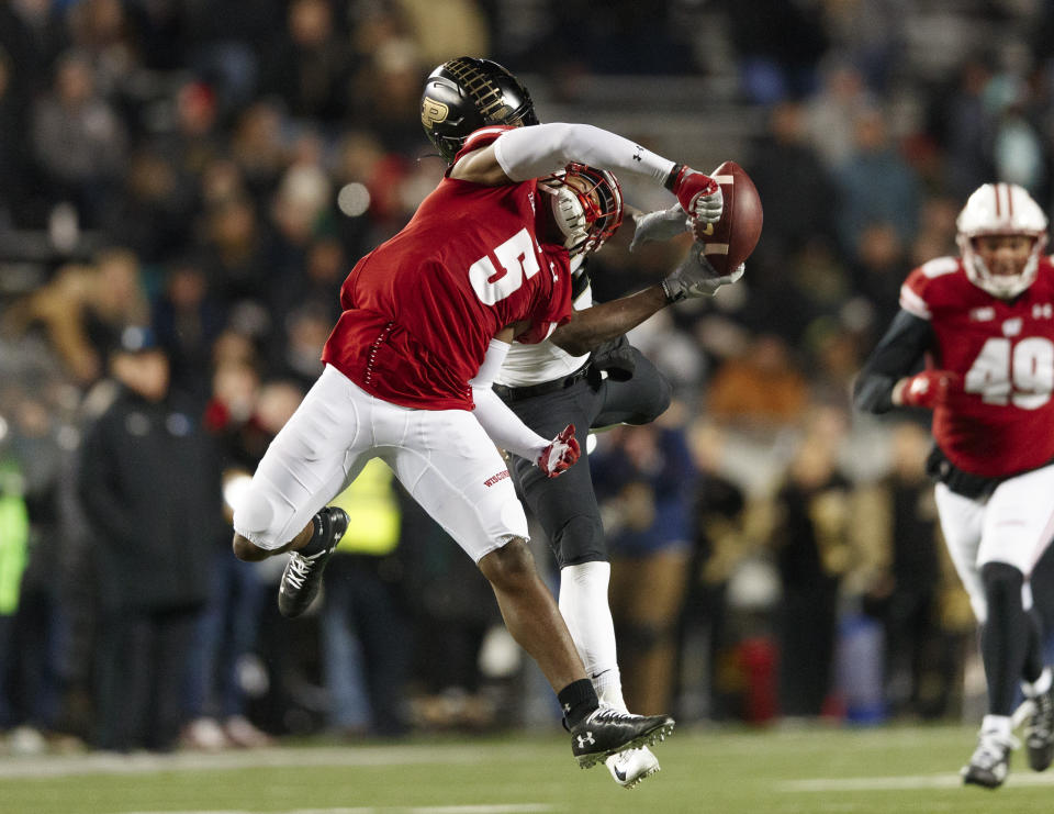 Nov 23, 2019; Madison, WI, USA; Wisconsin Badgers cornerback Rachad Wildgoose (5) breaks up the pass intended for Purdue Boilermakers wide receiver David Bell (3) during the fourth quarter at Camp Randall Stadium. Mandatory Credit: Jeff Hanisch-USA TODAY Sports