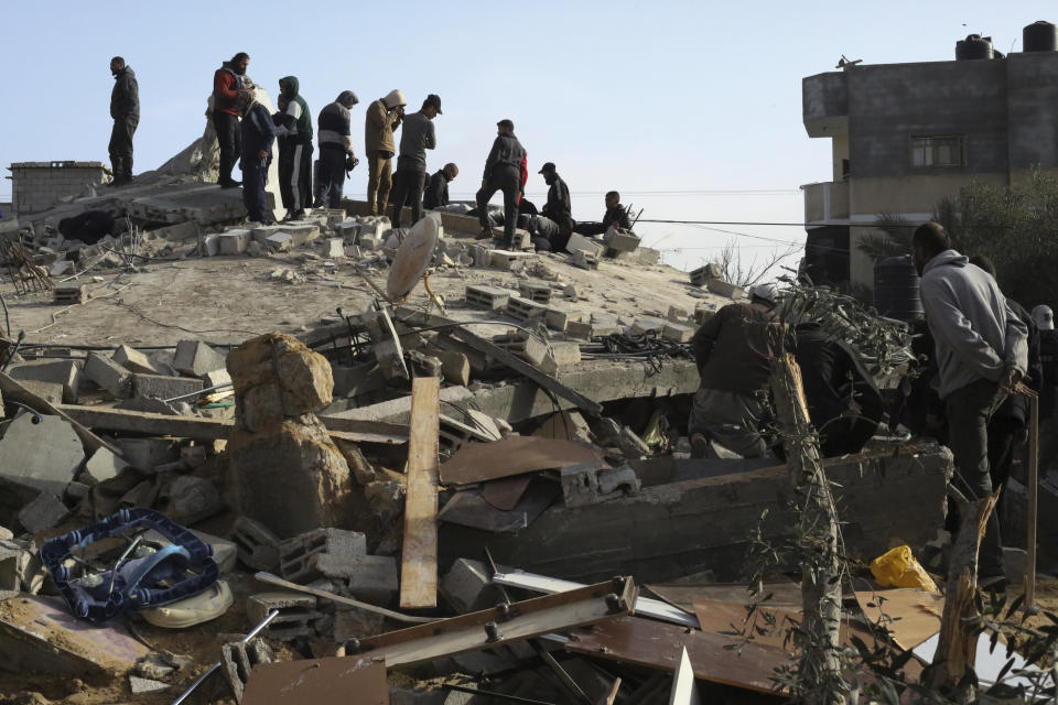 Palestinians look at the destruction after an Israeli strike on a residential building in Rafah, Gaza Strip, Sunday, March 3, 2024. (AP Photo/Hatem Ali)