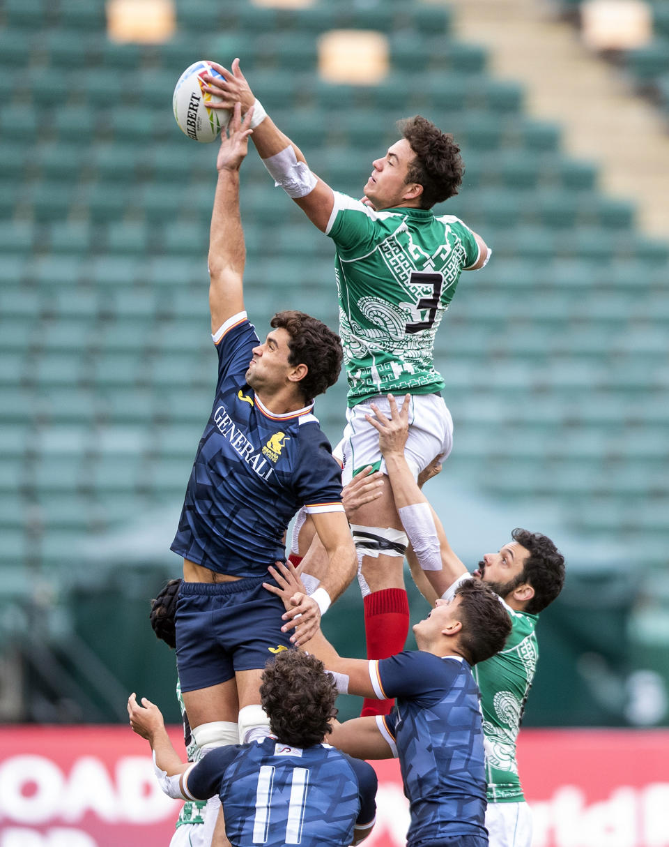 Spain's Manu Moreno, top left, and Mexico's Nicolas Falcon, top right, jump for the ball during an HSBC Canada Sevens quarterfinal rugby match in Edmonton, Alberta, Sunday, Sept. 26, 2021. (Jason Franson/The Canadian Press via AP)