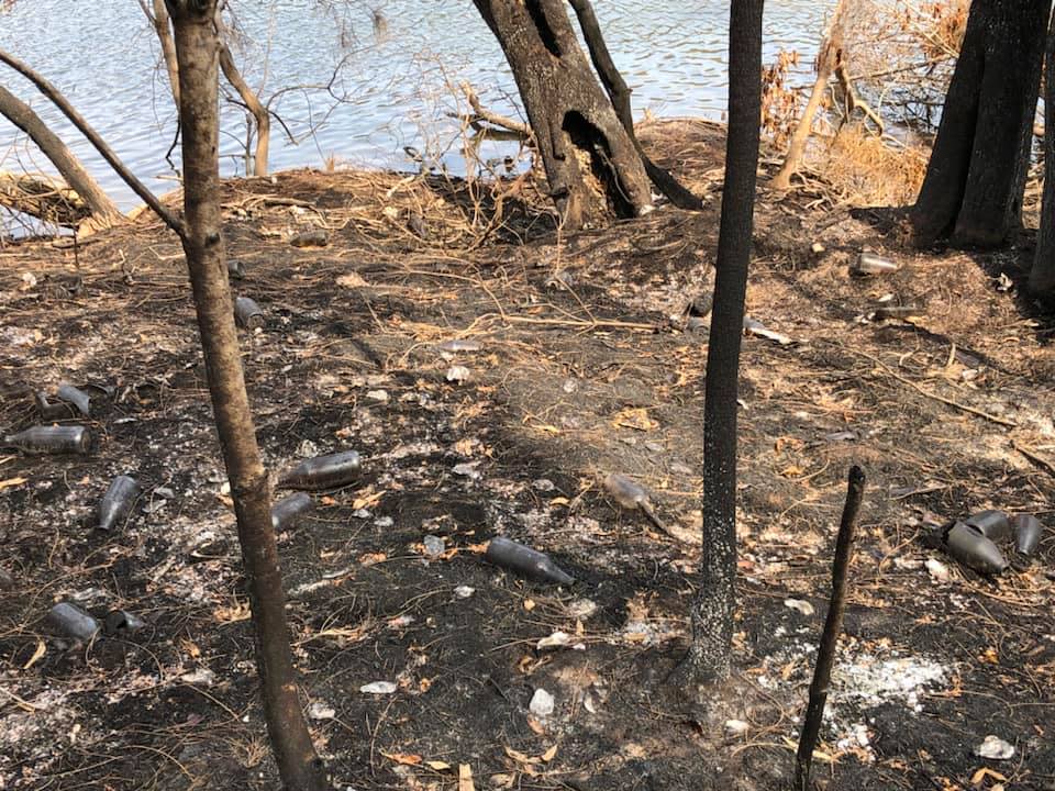 Clyde River National Park is pictured with a number of discarded beer bottles on the ground.