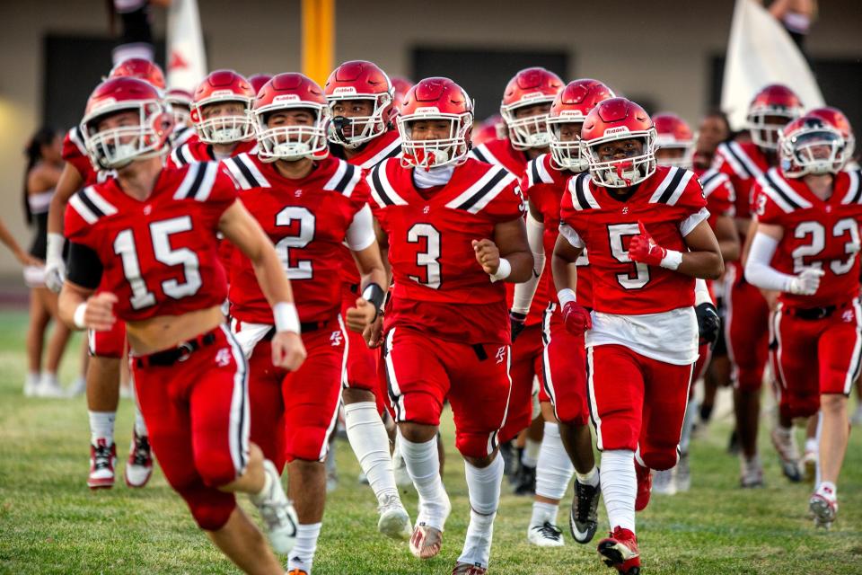 Palm Springs High School varsity football team enters the field for the game against Ramona of Riverside in Palm Springs, Calif., on Friday, September 8, 2023.