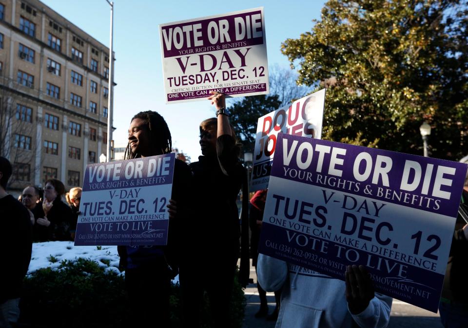 Demonstrators encourage people to vote at a rally for Senate candidate Doug Jones on Dec. 10, 2017, in Birmingham, Ala.