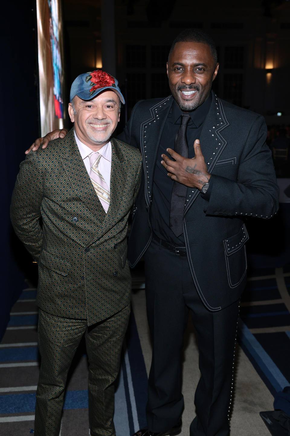 Christian Louboutin and Idris Elba backstage at the 2022 FNAAs. - Credit: Footwear News via Getty Images
