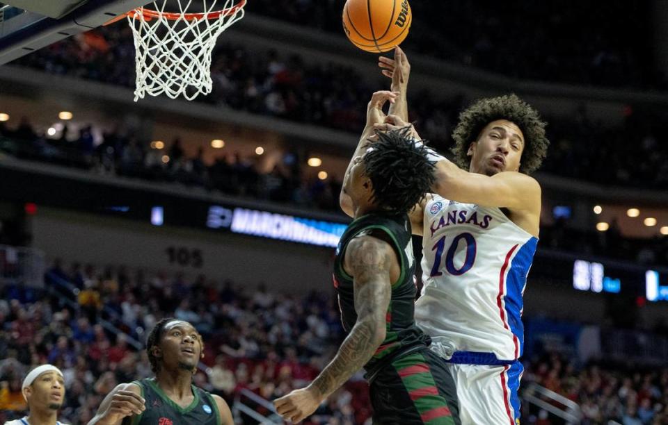 Kansas forward Jalen Wilson (10) and Howard guard Elijah Hawkins (3) battle for a rebound during a first-round college basketball game in the NCAA Tournament Thursday, March 16, 2023, in Des Moines, Iowa.
